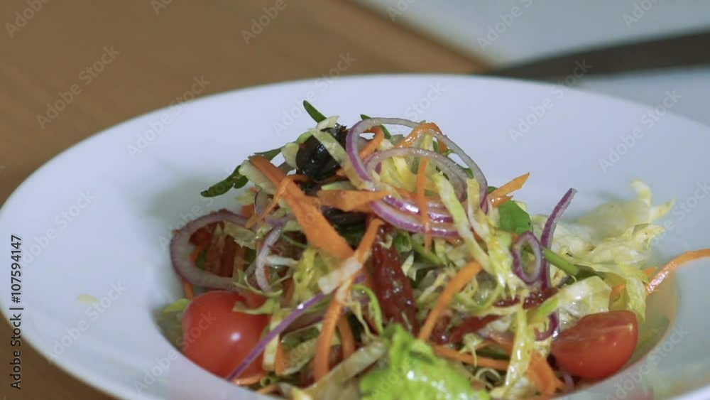 Closeup of pouring salad tomatos-cherry on plate. Slowly Closeup of pouring salad tomatos-cherry on plate. Slowly