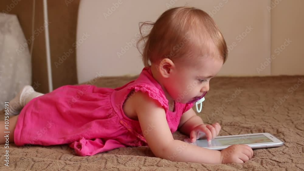Small kid lying on sofa and playing with tablet
Small kid lying on sofa and playing with tablet