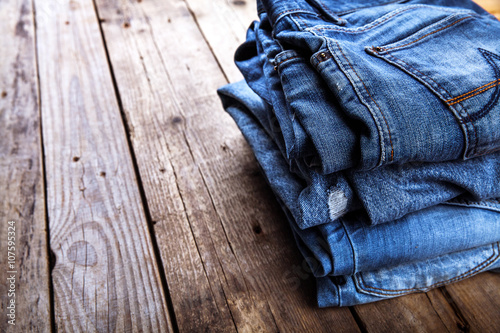 jeans stacked on a wooden background