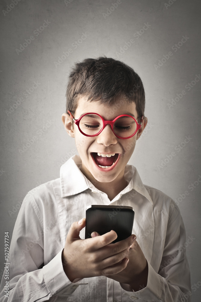 Kid using a smartphone Kid using a smartphone