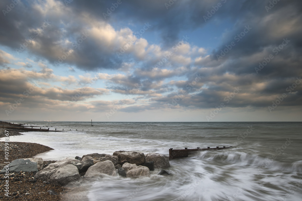 Fototapeta premium Beautiful long exposure sunset landscape image of pier at sea in