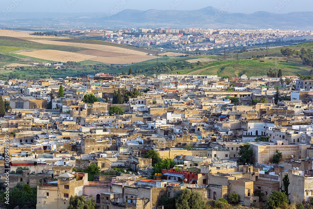 Aerial view of the crowded medina in the city of Fez, new city in the background.