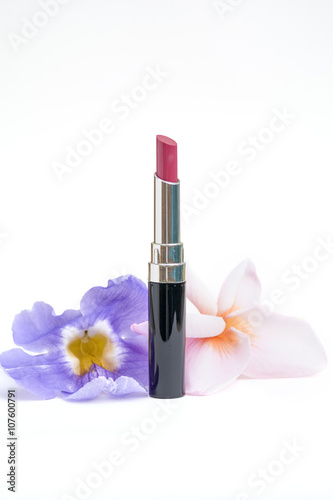 closeup natural rosy pink tone shiny lip stick whit flowers