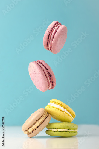 falling macarons on color background
