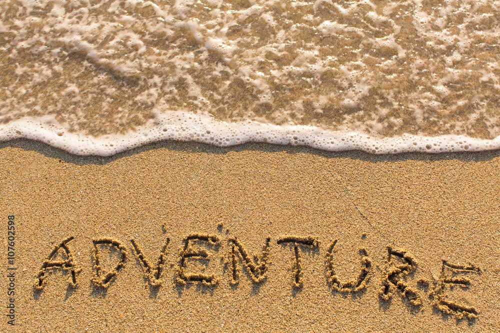 Fototapeta premium Adventure - drawn of the hand on the beach sand, soft surf wave.