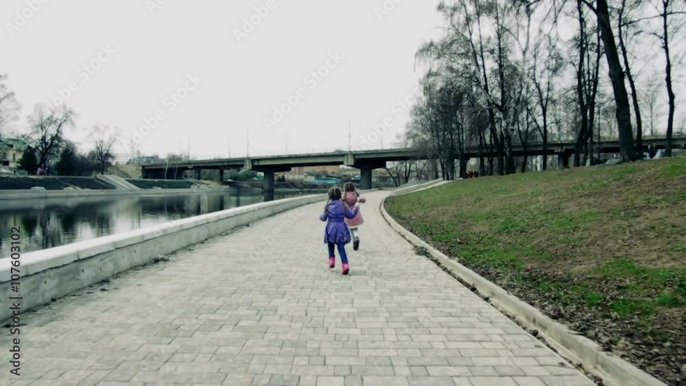 Two girls running around with soap bubbles (Steadicam) Two girls running around with soap bubbles (Steadicam)
