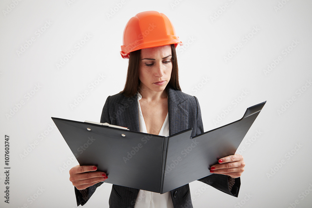 Woman in formal wear familiarize with the materials in folder Woman in formal wear familiarize with the materials in folder