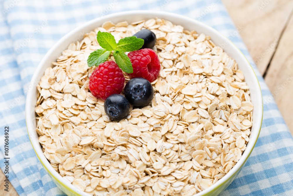 Oatmeal porridge with berries. Raspberries and blueberries. Oatmeal porridge with berries. Raspberries and blueberries.