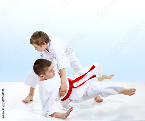 On a light background doing throws of judo athletes 
