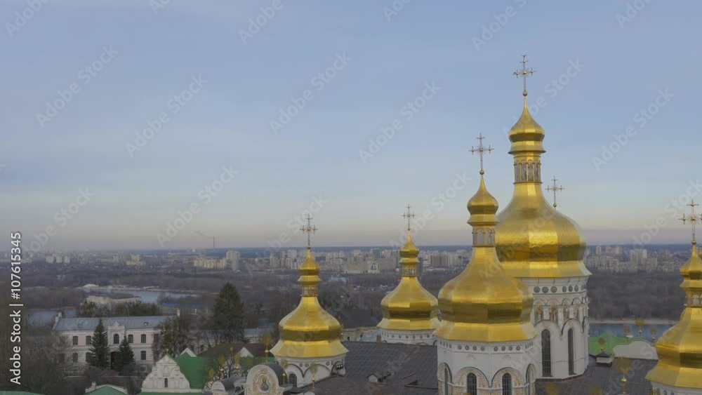 Golden Cupolas With Crosses of Holy Dormition Kiev-Pechersk Lavra Dormition Cathedral Kiev White Walls Green Roof Cityscape on a Horizon Cloudy Day Golden Cupolas With Crosses of Holy Dormition Kiev-Pechersk Lavra Dormition Cathedral Kiev White Walls Green Roof Cityscape on a Horizon Cloudy Day