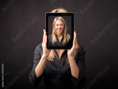 Woman holding tablet with her happy face