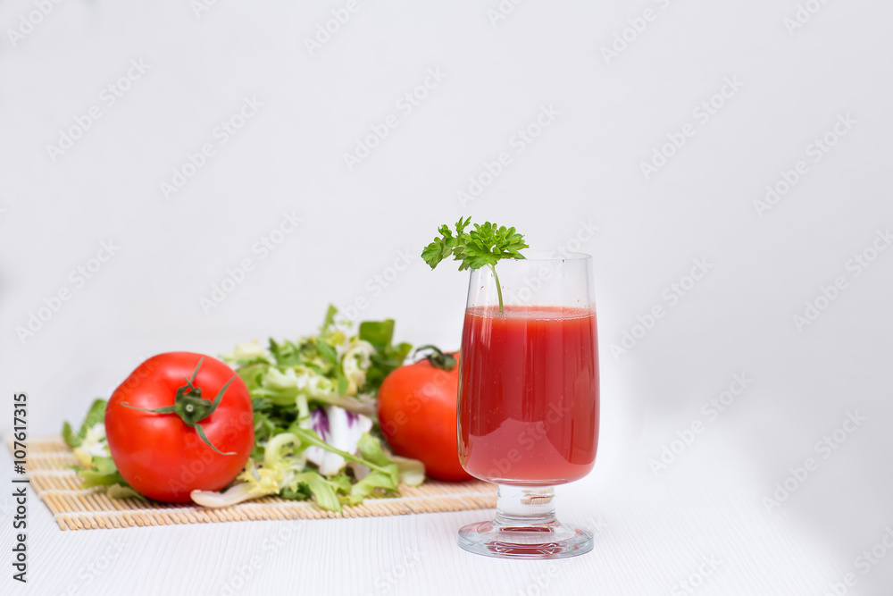 tomato juice in a glass with tomatoes and greens tomato juice in a glass with tomatoes and greens