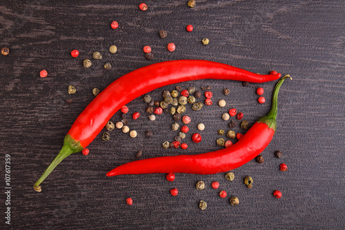 red pepper, pepper , rosemary on a black background