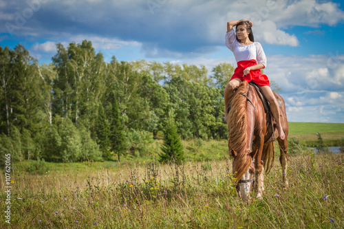 Woman sits on horseback © axlvideo
