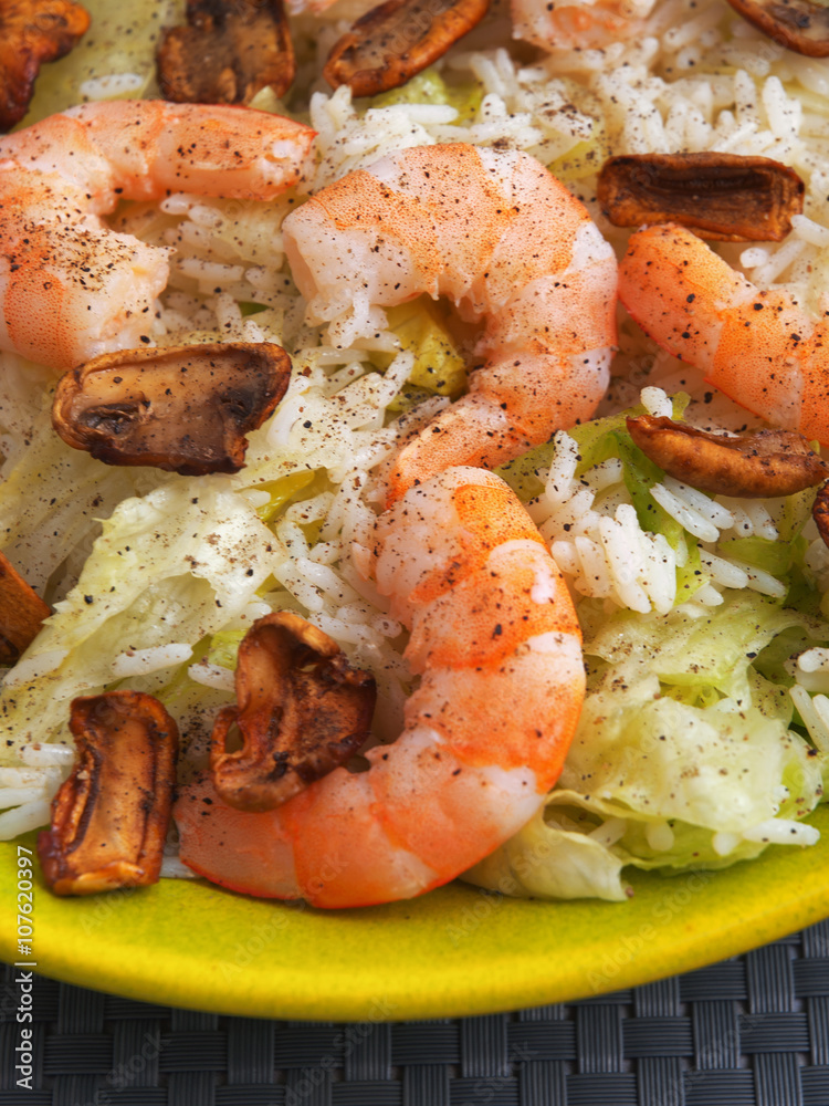Seafood salad with shrimps, iceberg, rice and mushrooms. Close up Seafood salad with shrimps, iceberg, rice and mushrooms. Close up