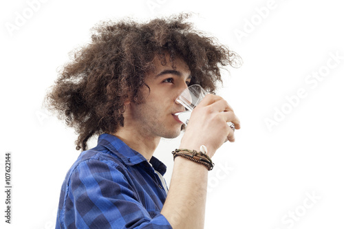 Young man drinking water from glass