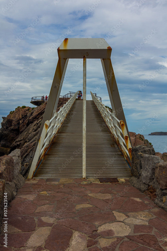 Iron bridge with wooden floors and rust by the sea, in Aviles, Spain Iron bridge with wooden floors and rust by the sea, in Aviles, Spain