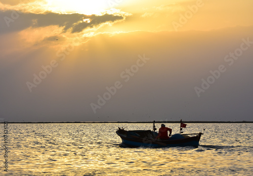 Fishing boat on sunset
