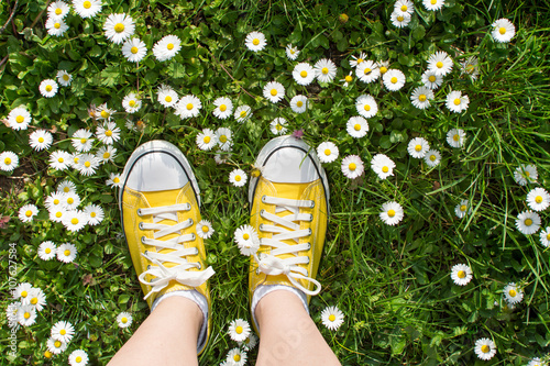 Yellow sneakers decorated with daisies
