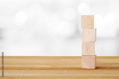 Fototapeta Naklejka Na Ścianę i Meble -  Four wooden cubes on table and blur bokeh background