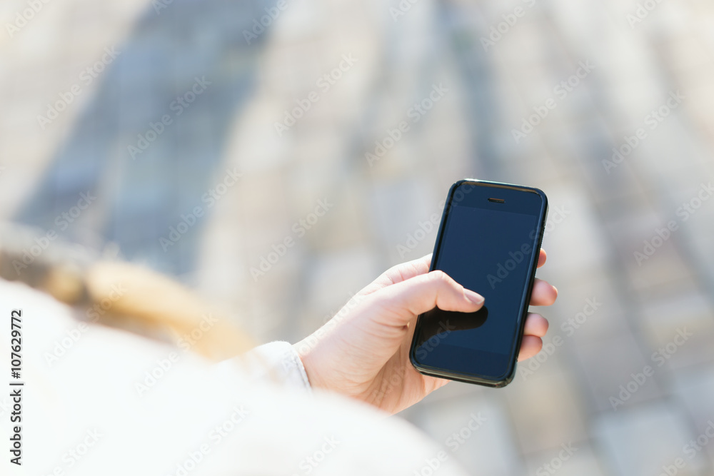 girl with smartphone outdoors in park. Closeup of female hands a girl with smartphone outdoors in park. Closeup of female hands a