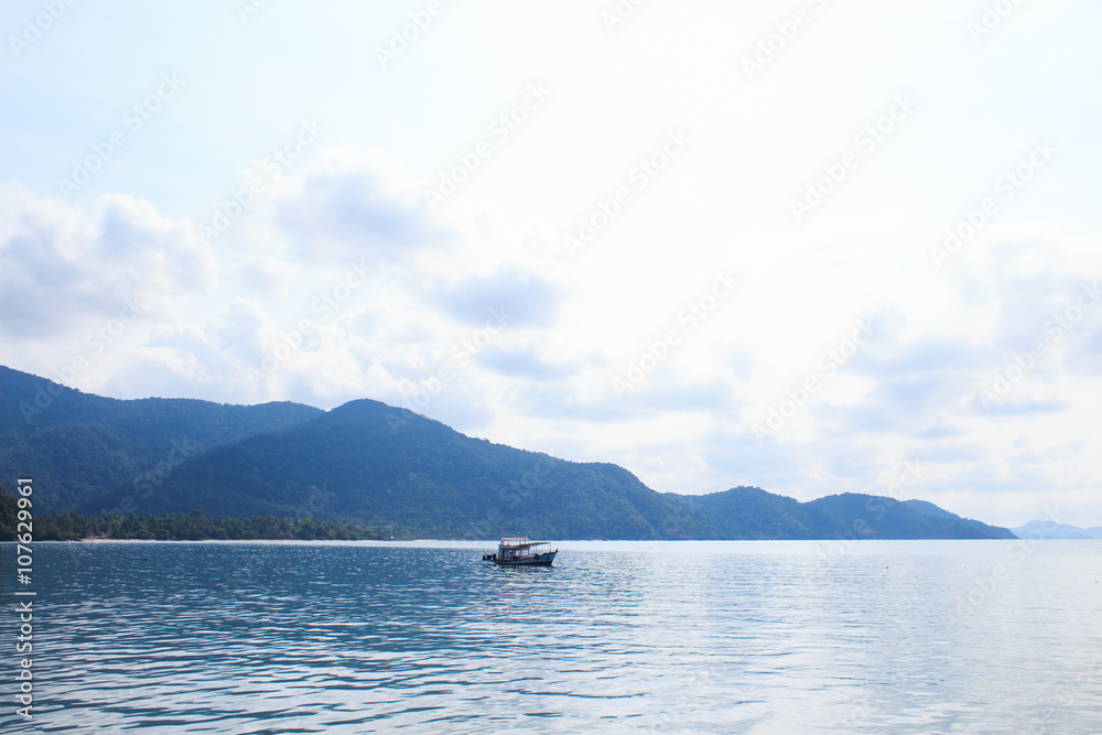 ship on blue sea and green island