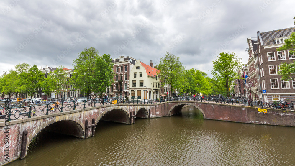 Fototapeta premium Bicycles lining a bridge over the canals of Amsterdam, Netherlands. 