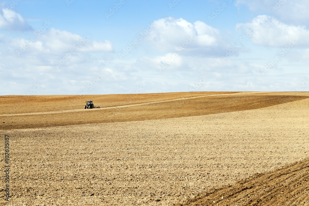 Fototapeta premium tractor plowing the fields 