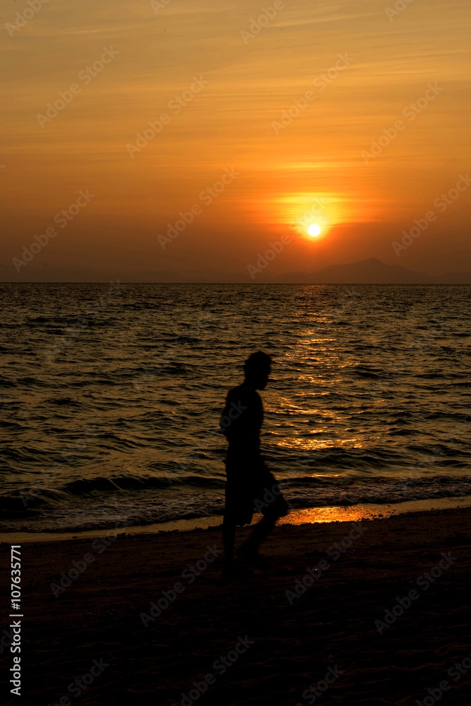 man walk on the beach on sunset time