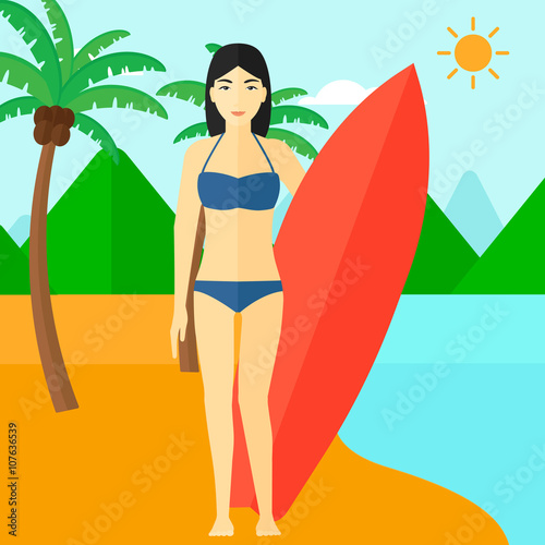 Surfer holding surfboard.