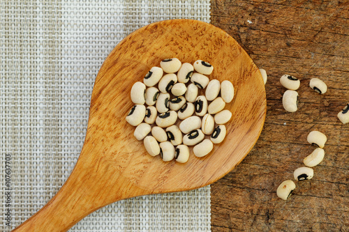 Black eye beans in wooden spoon