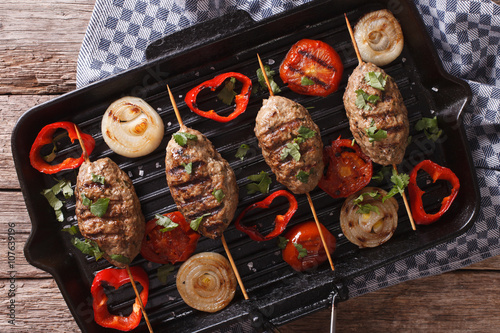 kebab with grilled vegetables on the grill pan close-up. horizontal top view 