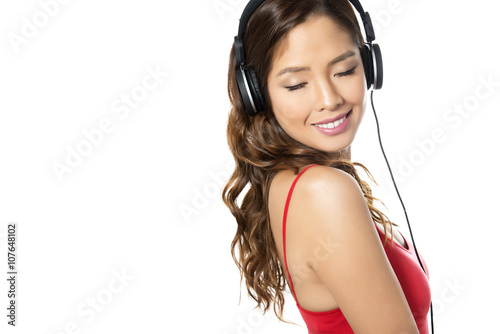 beautiful young asian woman listening to music with headphones isolated on white