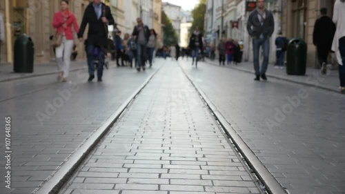 Peaople walking on the old pavement with old railroad. Timelaps
