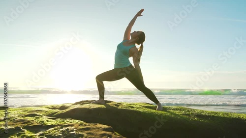 Happy young woman practicing yoga on the beach at sunset. Healthy active lifestyle concept. 4K photo