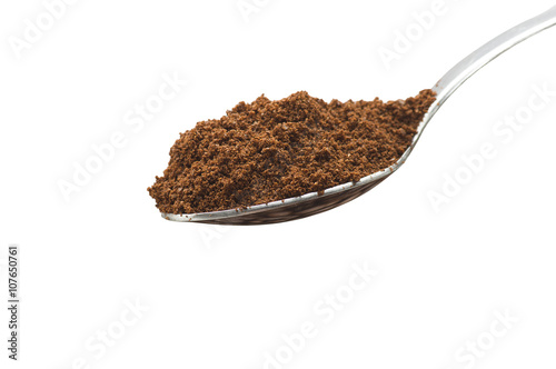 Iron spoon with coffee powder close up