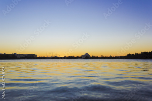 Scenic view of the early morning sunshine shimmering on the surface of the Tidal Basin looking eastwards towards the Jefferson Memorial, West Potomac Park, National Mall, Washington DC © Liberty Photo Art