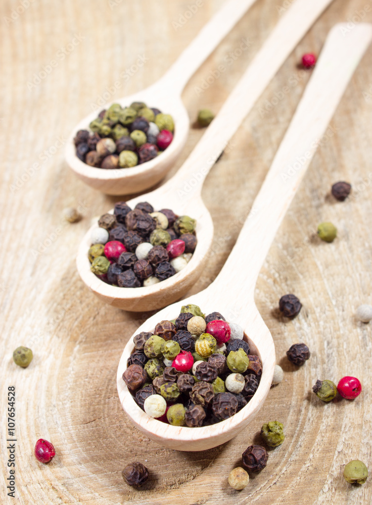 Color pepper on a wooden background. Color pepper on a wooden background.