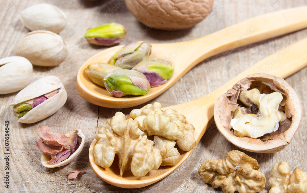 Closeup of a walnut and pistachios.