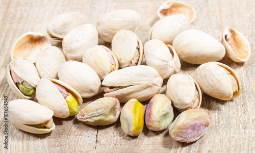 Pistachios on wood background.