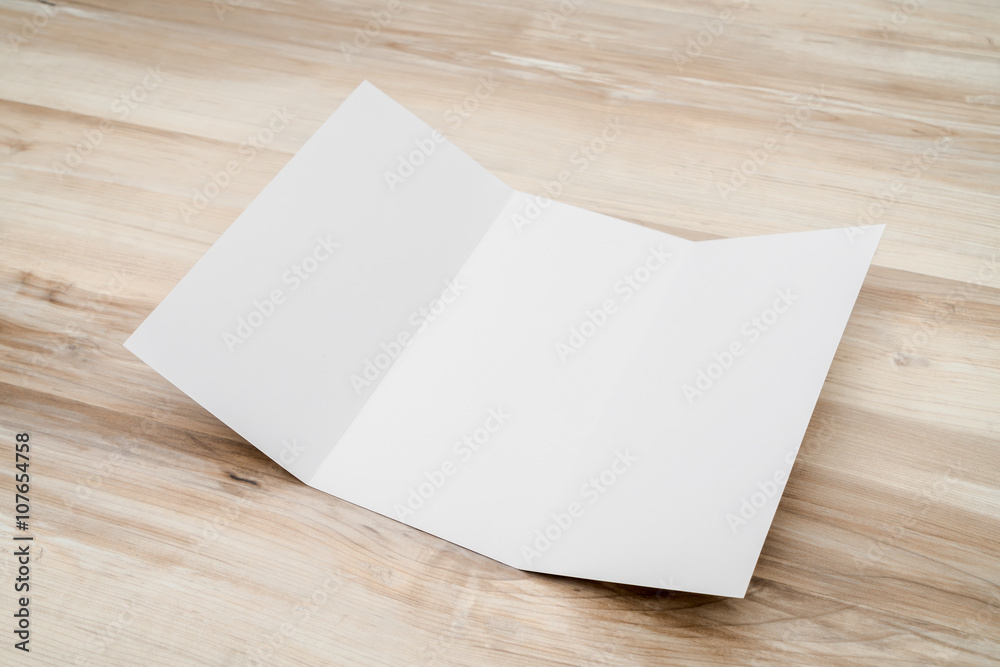 Trifold white template paper on wood texture.. Trifold white template paper on wood texture..