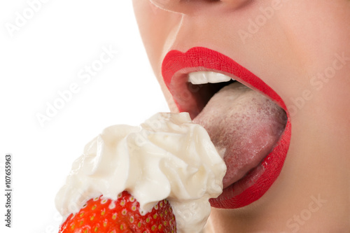 sexy woman eating strawberry with cream, sensual red lips