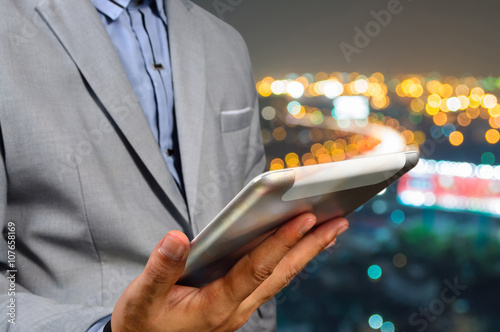 Bild auf Leinwand Handsome Business male in the city using his Smart Tablet PC wit