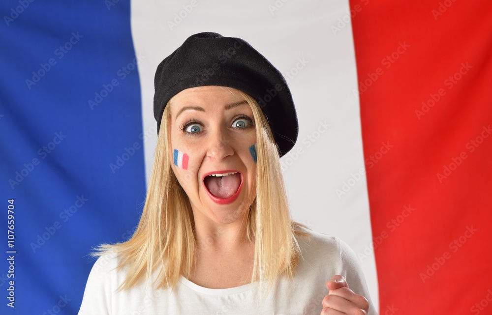 French soccer fan cheers football team in the national colors.
