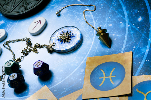 esoteric table with astrology and divination objects photo