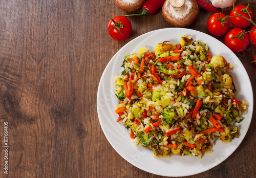 Mixed vegetables with rice in a plate on wooden table
