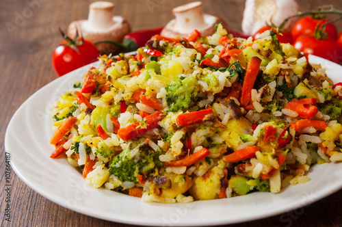 Mixed vegetables with rice in a plate on wooden table