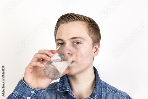 portrait of cute teenage boy drinking water © travelview