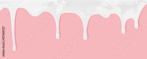 milk or white liquid dripping on pink background