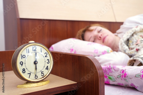 woman and alarm clock in the bedroom